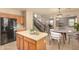 Modern kitchen area with island connects to staircase and dining room in open floor plan at 9207 W Kirby Ave, Tolleson, AZ 85353