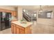 Kitchen area with island connects to staircase and dining room in open floor plan at 9207 W Kirby Ave, Tolleson, AZ 85353