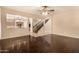 Living room area with hardwood floors and open view into the kitchen and staircase at 9207 W Kirby Ave, Tolleson, AZ 85353