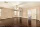 Spacious main bedroom features dark wood floors, ceiling fan, and ample natural light from large windows at 9207 W Kirby Ave, Tolleson, AZ 85353
