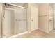 The shower features a glass enclosure, tile floor and shower head at 9207 W Kirby Ave, Tolleson, AZ 85353