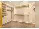 Walk-in closet features built-in shelving for easy organization of storage and clothing at 9207 W Kirby Ave, Tolleson, AZ 85353