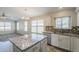 Modern kitchen featuring granite island, stainless appliances, tile backsplash and adjacent dining area at 9330 E Plana Ave, Mesa, AZ 85212