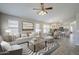 Bright open-concept living space with neutral tones and views into the dining area and kitchen at 9330 E Plana Ave, Mesa, AZ 85212
