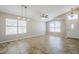 Bright living room with large windows and neutral tile flooring at 9330 E Plana Ave, Mesa, AZ 85212