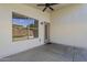 Covered patio features a ceiling fan, door to the house, and a window at 9330 E Plana Ave, Mesa, AZ 85212