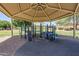 Community playground featuring shade structure, slides, and climbing equipment at 9330 E Plana Ave, Mesa, AZ 85212