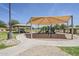 Community playground featuring shade structures, slides and other equipment at 9330 E Plana Ave, Mesa, AZ 85212