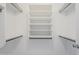 Walk-in closet with white shelving and metal racks at 9330 E Plana Ave, Mesa, AZ 85212