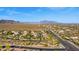 Scenic aerial view capturing the community and streetscape against the backdrop of desert mountains at 9532 E Knoll Cir, Mesa, AZ 85207
