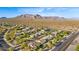 High aerial showcasing community homes with desert landscape and desert mountain views in the distance at 9532 E Knoll Cir, Mesa, AZ 85207