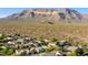 Picturesque aerial view showcasing desert community surrounded by desert trees and mountain views at 9532 E Knoll Cir, Mesa, AZ 85207