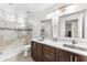 Bright bathroom with double vanity, modern fixtures, and a glass-enclosed shower at 9532 E Knoll Cir, Mesa, AZ 85207