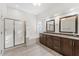 Beautiful bathroom featuring a glass-enclosed shower, soaking tub and dual sink vanity with granite countertops at 9532 E Knoll Cir, Mesa, AZ 85207