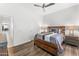 Inviting bedroom with wood floors, soft lighting, and a calming, neutral color scheme at 9532 E Knoll Cir, Mesa, AZ 85207