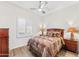 Comfortable bedroom with wooden furnishings, a patterned quilt, and shuttered window at 9532 E Knoll Cir, Mesa, AZ 85207