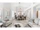 Spacious dining room with travertine floors, high ceilings, and elegant chandelier at 9532 E Knoll Cir, Mesa, AZ 85207