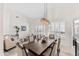 Spacious dining room with vaulted ceilings, modern lighting, and neutral décor at 9532 E Knoll Cir, Mesa, AZ 85207