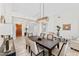 Inviting dining area with a large dining table and decorative lighting fixture at 9532 E Knoll Cir, Mesa, AZ 85207