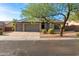 Charming single-story home featuring a three-car garage and mature desert landscaping at 9532 E Knoll Cir, Mesa, AZ 85207