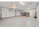 Spacious three-car garage with epoxy flooring and ample storage space at 9532 E Knoll Cir, Mesa, AZ 85207