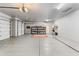 Spacious three-car garage with epoxy flooring and ample storage space at 9532 E Knoll Cir, Mesa, AZ 85207