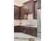 Close-up of custom kitchen cabinets, tile backsplash, granite countertop, and modern appliances at 9532 E Knoll Cir, Mesa, AZ 85207