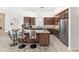 Gourmet kitchen with stainless appliances, granite countertops, and breakfast bar seating at 9532 E Knoll Cir, Mesa, AZ 85207