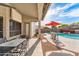 Inviting covered patio with outdoor dining area overlooking the sparkling pool at 9532 E Knoll Cir, Mesa, AZ 85207