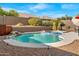 Backyard pool and waterfall feature with desert landscaping and privacy wall at 9532 E Knoll Cir, Mesa, AZ 85207