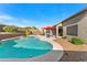 Inviting backyard pool with a spa, desert landscaping, and ample seating areas at 9532 E Knoll Cir, Mesa, AZ 85207