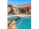 Stunning pool and spa featuring a rock waterfall, covered patio, and desert landscaping at 9532 E Knoll Cir, Mesa, AZ 85207
