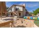 Backyard patio featuring comfortable seating, a dining area, and a hot tub at 987 E Divot Dr, Tempe, AZ 85283