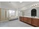 Bright bathroom with a soaking tub, shower and a double sink vanity and a skylight at 987 E Divot Dr, Tempe, AZ 85283