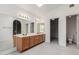 Bathroom featuring a large mirror, a double sink vanity and access to a walk-in closet and toilet at 987 E Divot Dr, Tempe, AZ 85283