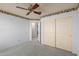 Bedroom with a ceiling fan, carpet and closet, offering space and comfort at 987 E Divot Dr, Tempe, AZ 85283