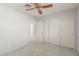 Bedroom with a ceiling fan, carpet and closet, offering space and comfort at 987 E Divot Dr, Tempe, AZ 85283