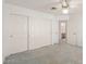 Bedroom with a ceiling fan, carpet and closet, offering space and comfort at 987 E Divot Dr, Tempe, AZ 85283