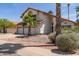 The beautiful home has a three-car garage and desert landscaping, creating an inviting curb appeal at 987 E Divot Dr, Tempe, AZ 85283
