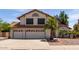 Charming two-story home with a red tile roof, a three-car garage, and mature palm trees at 987 E Divot Dr, Tempe, AZ 85283