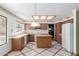 Spacious kitchen with an island, white appliances and light wood cabinets and tile flooring at 987 E Divot Dr, Tempe, AZ 85283