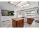 Bright kitchen with island, wood cabinets, white appliances, and a view to the backyard at 987 E Divot Dr, Tempe, AZ 85283