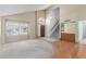 Bright living room with large windows, hardwood floors, and a classic front door entrance at 987 E Divot Dr, Tempe, AZ 85283