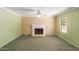 Inviting living room with a traditional fireplace, ceiling fan, and a bright window at 987 E Divot Dr, Tempe, AZ 85283