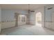 Main bedroom with a ceiling fan, carpet floors, and a view of an en-suite bathroom at 987 E Divot Dr, Tempe, AZ 85283
