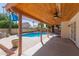 A covered patio features a wood ceiling, a fan, and a view of the pool and backyard at 987 E Divot Dr, Tempe, AZ 85283