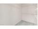 Walk-in closet with built in metal shelving units, with carpeted floors and white walls at 987 E Divot Dr, Tempe, AZ 85283