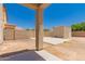 A spacious backyard with covered patio space, and block fence at 10009 W Bloch Rd, Tolleson, AZ 85353