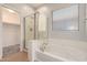 Bathroom boasting a tub and glass-enclosed shower at 10009 W Bloch Rd, Tolleson, AZ 85353