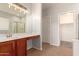 Bathroom featuring double sinks, tile flooring, and glass-enclosed shower at 10009 W Bloch Rd, Tolleson, AZ 85353